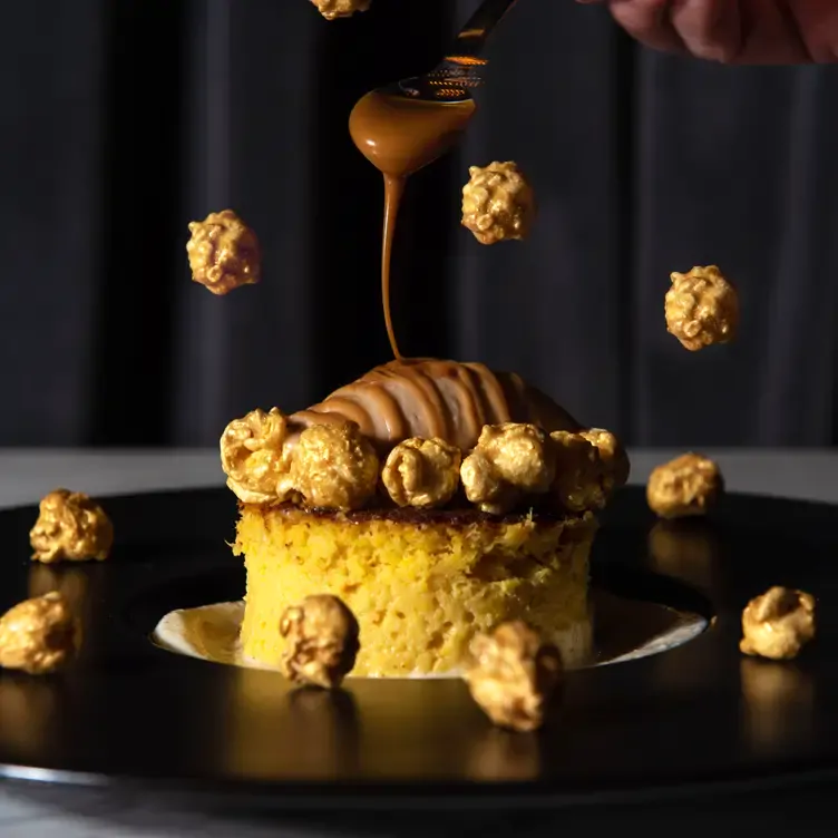 Una persona derrama cajeta en un postre de SIBAU, uno de los mejores restaurantes contemporáneos en Monterrey.