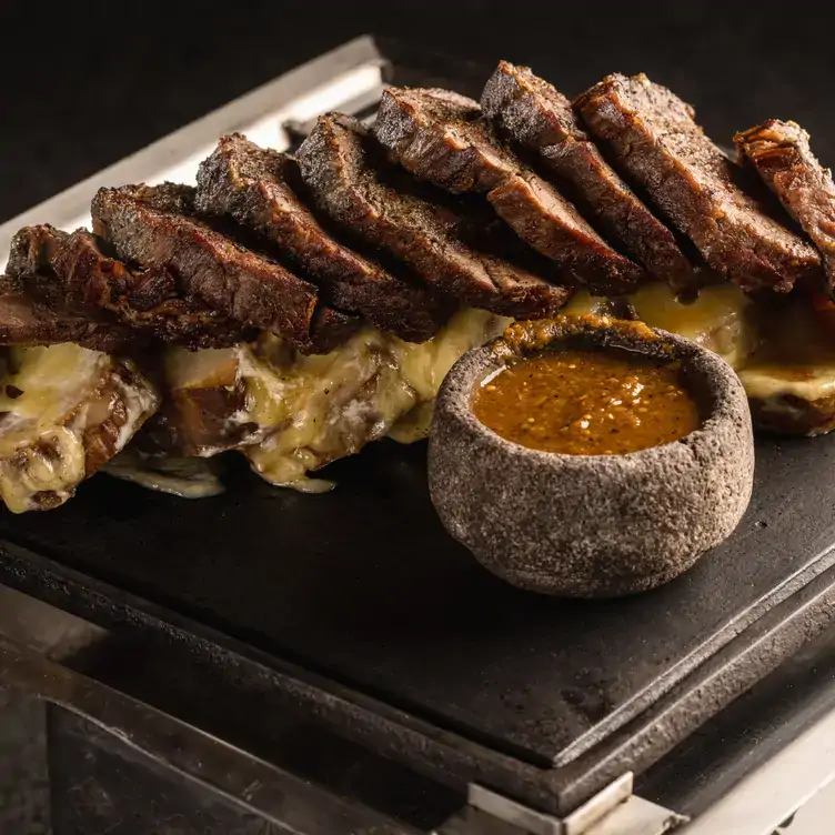 A table with cuts of meat and salsa at Porfirio's, one of the best Mexican restaurants in CDMX.