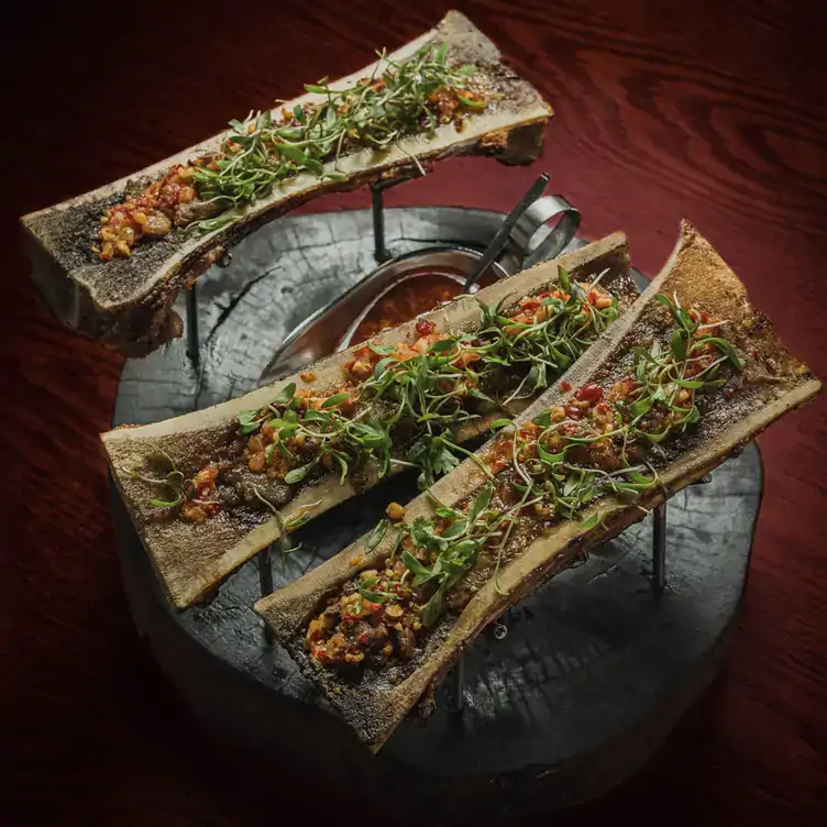 Bone marrow with vegetables on a wooden board at Rosa Negra, one of the best restaurants in Mexico City.