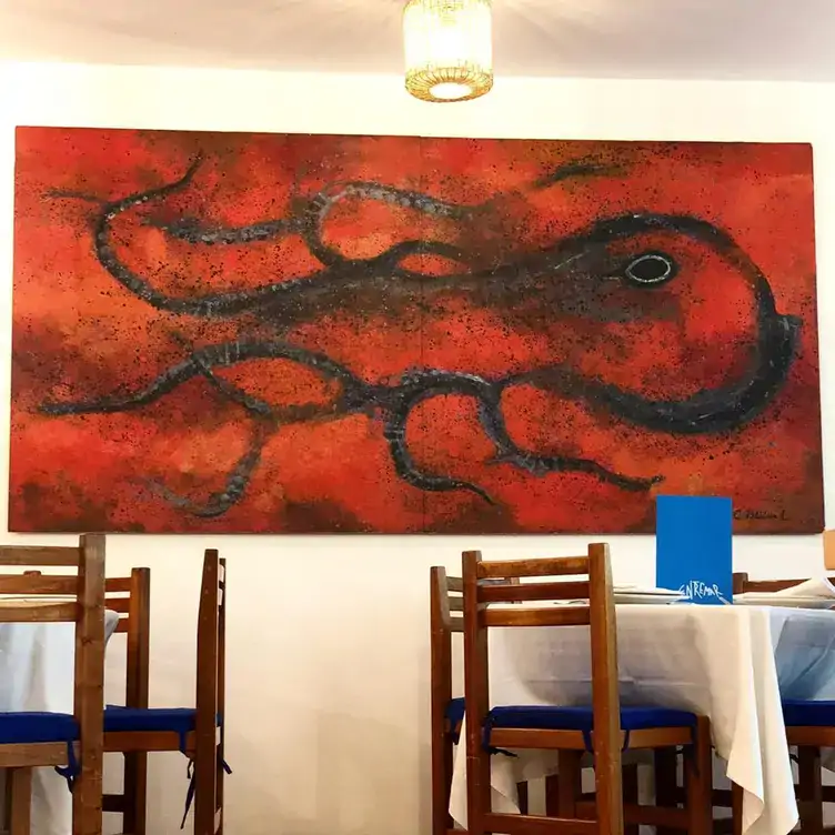 A picture with an octopus and white tables of Entremar, one of the best restaurants in Mexico City.