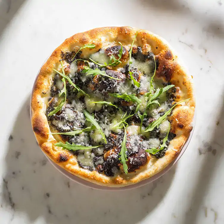 A baked dish with bread and vegetables at Huset, one of the best dining options in Mexico City.