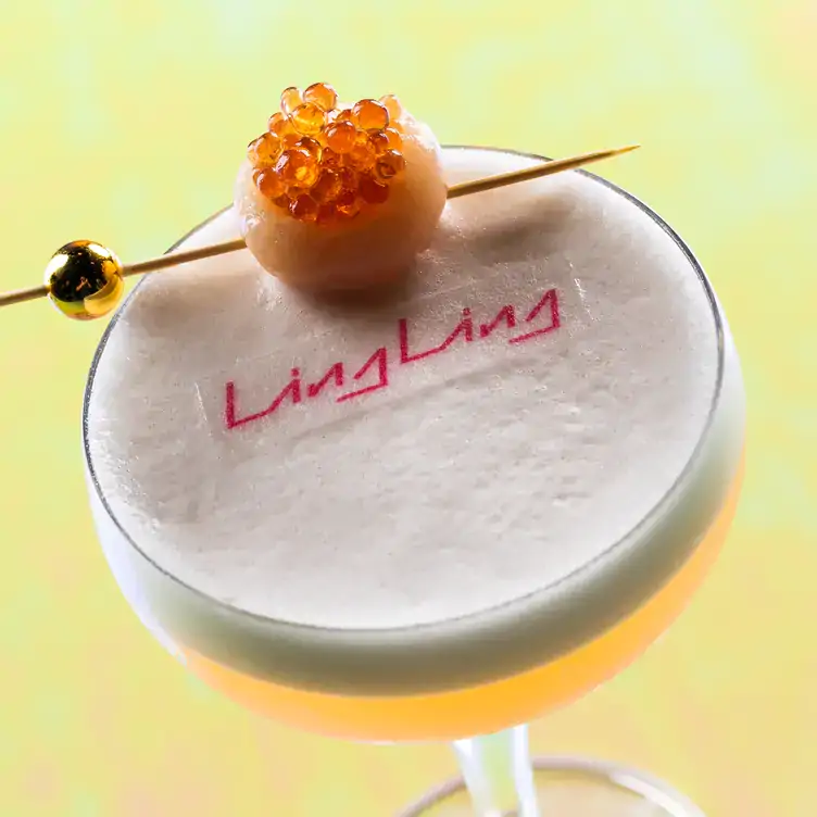 A glass with a cocktail, decorated with pearls and a toothpick at Ling Ling Mexico.