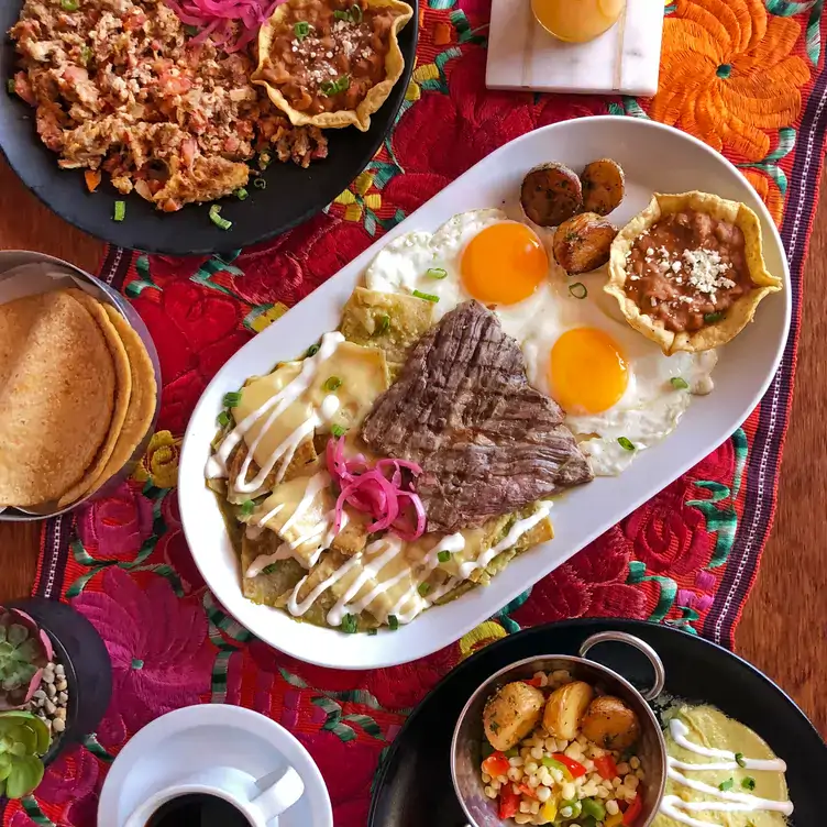 Unos chilaquiles verdes acompañados de arrachera, dos huevos estrellados, frijoles y papas cambray en Chepil Cocina Mexicana, uno de los mejores restaurantes para desayunar en Tijuana.