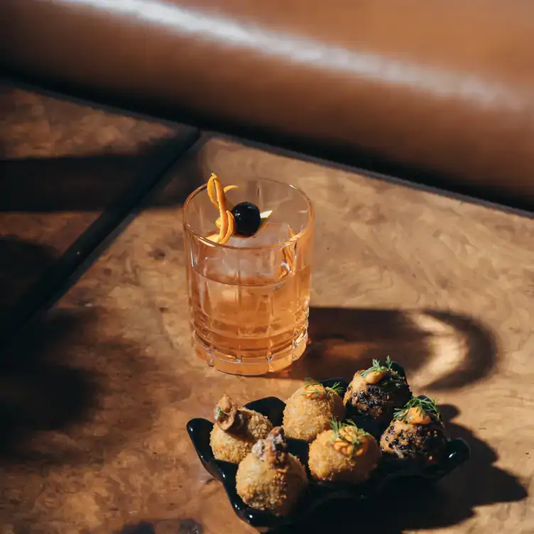 A cocktail and a plate of croquettes at Fifty Mils, one of the best bars in Mexico City